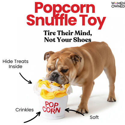 Dog playing with a popcorn-themed snuffle toy on a white background
